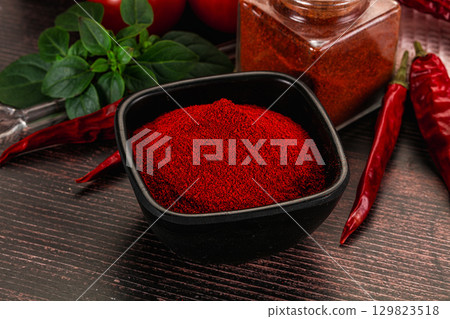 Spicy dry paprika powder in the bowl Spicy dry paprika powder in the bowl 129823518