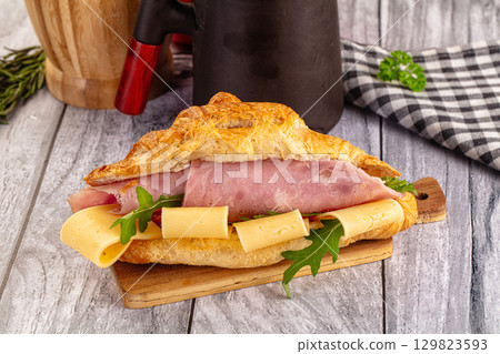 Fresh croissant with ham and cheese Fresh croissant with ham and cheese 129823593