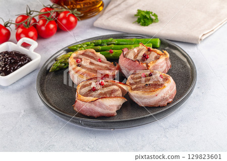 Tasty grilled pork medallion with bacon Tasty grilled pork medallion with bacon 129823601