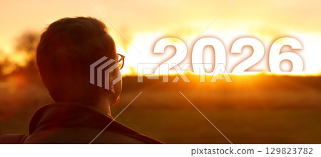 a man standing outside, his face turned toward the sunlight. concept of hope and wellness in the year 2026. hope concept man 2026 a man standing outside, his face turned toward the sunlight. concept of hope and wellness in the year 2026. hope concept man 2026 129823782