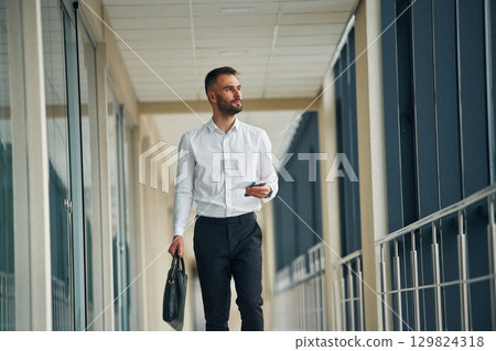 In formal clothes. Young handsome man in the airport In formal clothes. Young handsome man in the airport 129824318