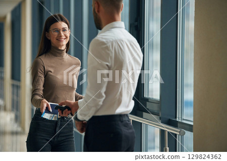 Woman is with airport worker, with tickets 129824362