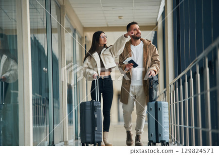 In the airport hall, walking. Couple are together 129824571