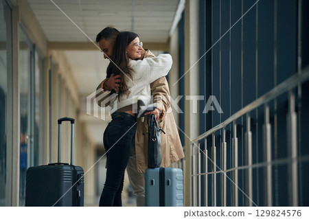 Farewell, embracing each other. Couple are in the airport hall together Farewell, embracing each other. Couple are in the airport hall together 129824576