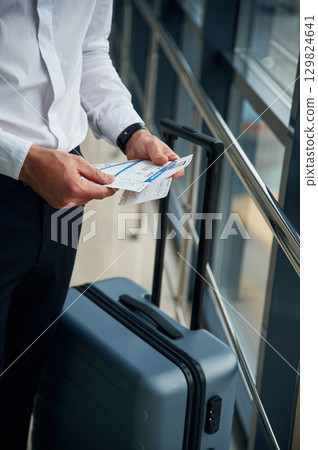 Close up view of man with luggage and in formal clothes, conception of airport travel 129824641