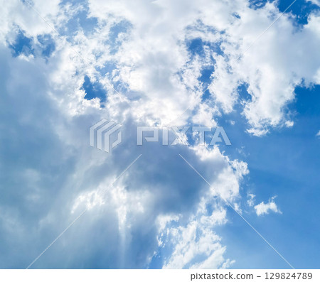Bright blue sky with fluffy white clouds creating a serene and tranquil atmosphere above Bright blue sky with fluffy white clouds creating a serene and tranquil atmosphere above 129824789