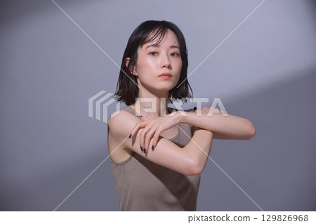 Beauty image: Young woman touching her arm 129826968