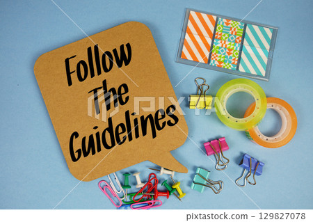 Follow The Guidelines text with stationery on blue background 129827078