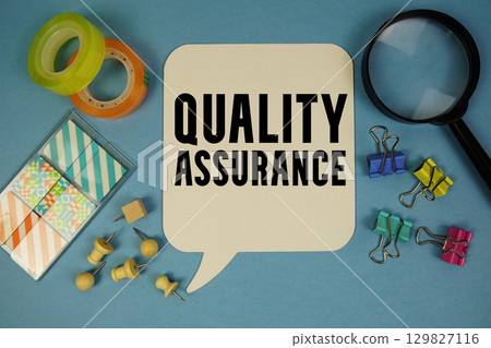 Quality Assurance text with magnifying glass on blue background 129827116