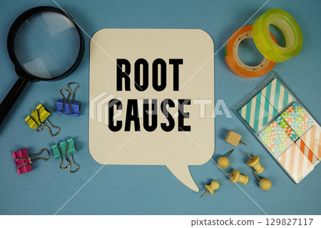 Root Cause text with magnifying glass on blue background 129827117