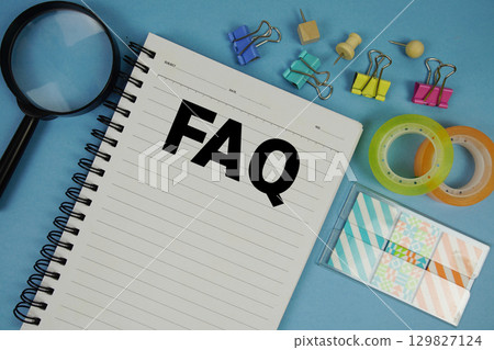 FAQ frequently asked questions text with magnifying glass on blue background FAQ frequently asked questions text with magnifying glass on blue background 129827124
