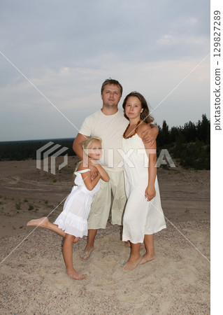 Cute family. Father, mother and daughter outdoors 129827289