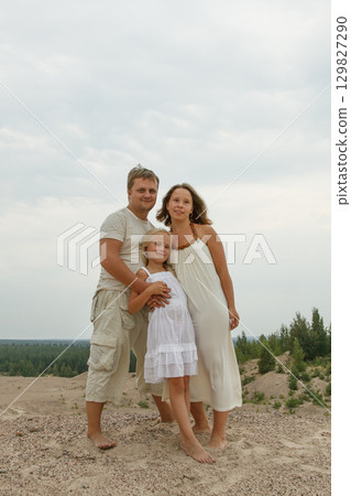 Smiling family. Father, mother and daughter outdoors 129827290