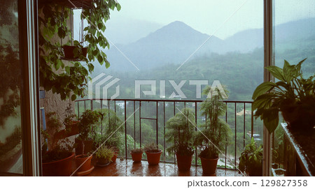 Rainy day view from a cozy balcony with greenery 129827358