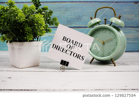 Board Of Directors text written on paper card with alarm clock on wooden background Board Of Directors text written on paper card with alarm clock on wooden background 129827584