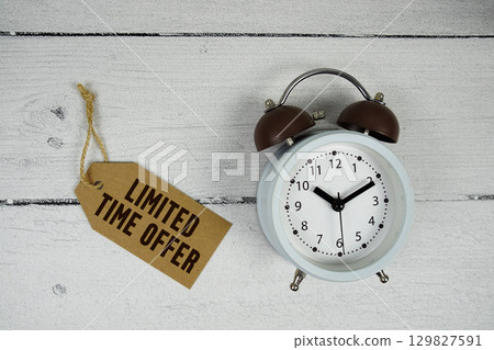 Limited Time Offer text with alarm clock on wooden background Limited Time Offer text with alarm clock on wooden background 129827591