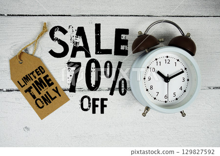 Sale 70% Limited Time Offer text with alarm clock on wooden background Sale 70% Limited Time Offer text with alarm clock on wooden background 129827592