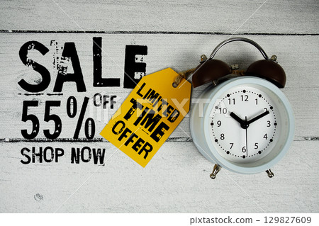 Sale 55% of Limited Time Offer text with alarm clock on wooden background 129827609