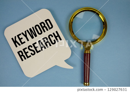 Key Research text with magnifying glass on blue background 129827631