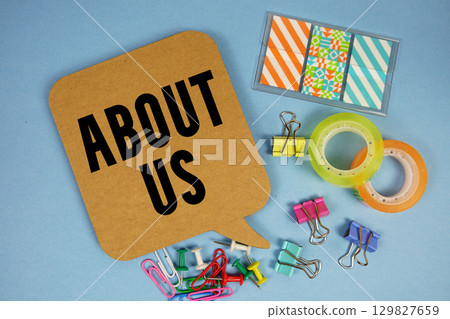 About Us text with stationery on blue background 129827659