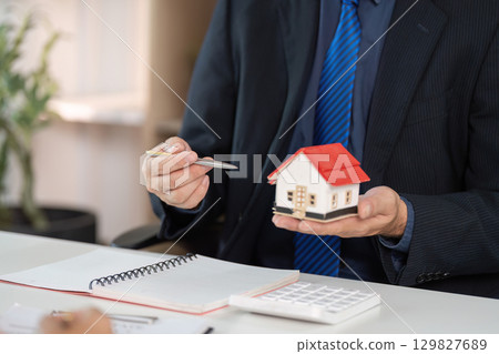 Real Estate Agent. Professional presenting a model house to a client. 129827689