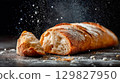 Freshly baked ciabatta bread on a dark surface 129827950