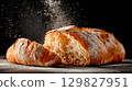 Ciabatta bread with flour dust on dark background 129827951