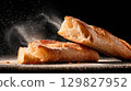 Freshly baked ciabatta bread on a dark surface 129827952
