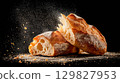 Freshly baked ciabatta on a dark background 129827953