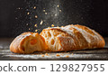 Freshly baked ciabatta bread on a dark surface 129827955