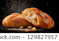 Enjoying fresh ciabatta bread on a dark background 129827957