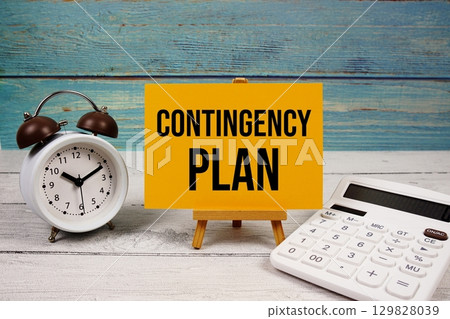Contingency Plan text written on paper card with calculator and alarm clock on wooden background Contingency Plan text written on paper card with calculator and alarm clock on wooden background 129828039