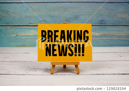 Breaking News text written on paper card on wooden background Breaking News text written on paper card on wooden background 129828104