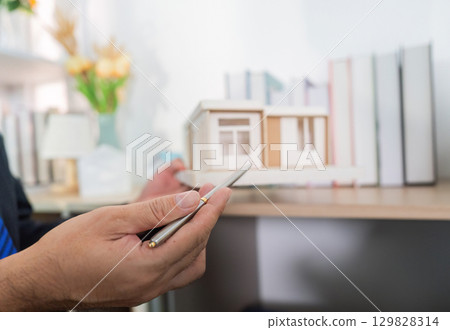 Model Home Overview. Real estate agent discussing features with client. 129828314