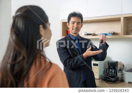 Real Estate Agent Handing Over Keys to New Home 129828343
