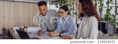 Engaging in a Collaborative Team Meeting within a Modern and Innovative Workspace Setting 129828441