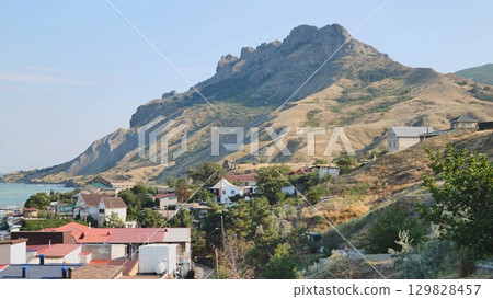 Koktebel town rising on Crimean coast under Kara Dag mountain 129828457