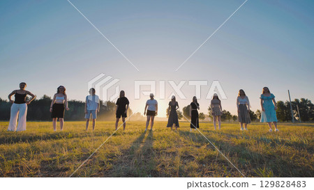 Summer vacation, students posing together in a sunlit field, capturing carefree moments of friendship and joy Summer vacation, students posing together in a sunlit field, capturing carefree moments of friendship and joy 129828483