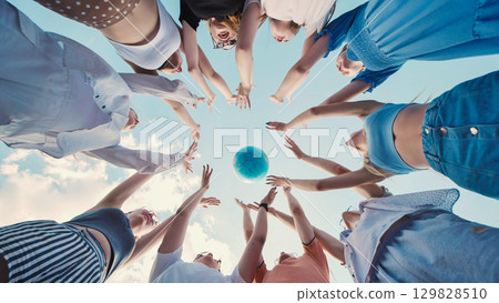 Students reaching for a globe, symbolizing global citizenship, environmental awareness, and international cooperation for a sustainable future Students reaching for a globe, symbolizing global citizenship, environmental awareness, and international cooperation for a sustainable future 129828510