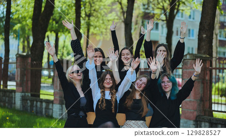 Happy students raising their hands outside, celebrating the end of the school day Happy students raising their hands outside, celebrating the end of the school day 129828527