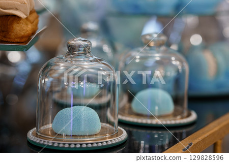 Pastel Macarons Display in Glass Cloches. Blue Confectionery, Bakery Interior, Vintage Style, Dessert Presentation, Sweet Treats, Selective Focus. 129828596