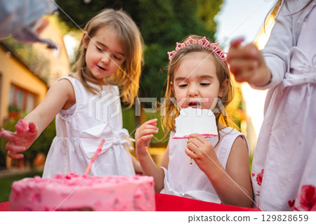 Joyful birthday celebration with children and cake Joyful birthday celebration with children and cake 129828659