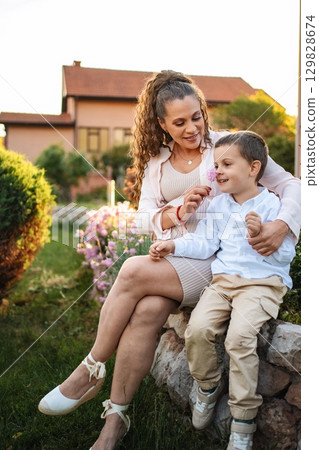 Joyful moments shared between mother and son in nature Joyful moments shared between mother and son in nature 129828674