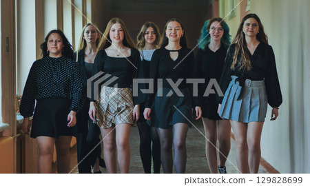 High school students strolling through a busy school corridor, savoring their break and creating lasting friendships 129828699