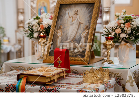 Transfiguration of Jesus Christ Icon in Eastern Orthodox Church Altar with Flowers and Religious Objects. Transfiguration of Jesus Christ Icon in Eastern Orthodox Church Altar with Flowers and Religious Objects. 129828783
