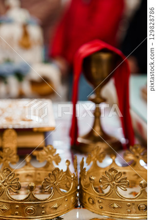 Golden Chalice and Sacred Objects in Eastern Orthodox Church Ritual, Red Cloth Drapery, Detailed Interior, Religious Ceremony Photography. Golden Chalice and Sacred Objects in Eastern Orthodox Church Ritual, Red Cloth Drapery, Detailed Interior, Religious Ceremony Photography. 129828786