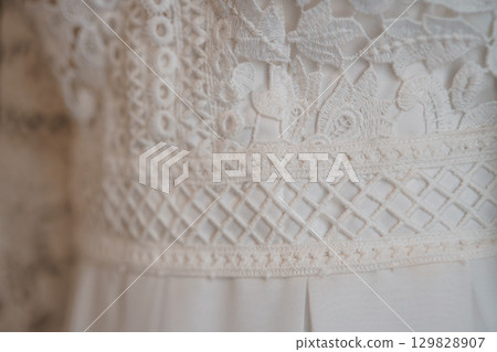 Intricate Ivory Lace Wedding Dress Bodice Detail, Floral Embroidery, Textured Fabric Close-Up, Elegant Bridal Gown, Romantic Style, Soft Lighting Intricate Ivory Lace Wedding Dress Bodice Detail, Floral Embroidery, Textured Fabric Close-Up, Elegant Bridal Gown, Romantic Style, Soft Lighting 129828907