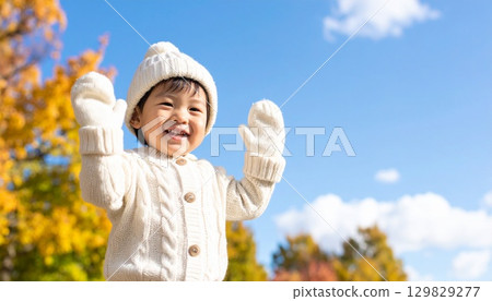 Young children playing happily in the park Autumn/winter image material 129829277