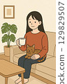 A woman taking a break with a cat in the living room 1 129829507