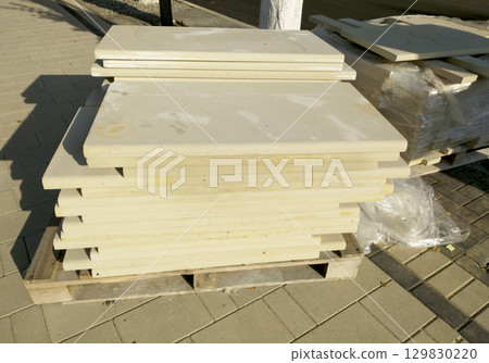 stone tiles for facing the facade of the building are stacked on a wooden pallet stone tiles for facing the facade of the building are stacked on a wooden pallet 129830220